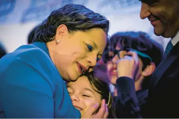  ?? JOHN C. CLARK/AP ?? Virginia Democrat Jennifer McClellan celebrates with her family after she won a seat in the U.S. House in a special election Tuesday.