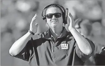  ?? Ben Margot / AP ?? New York Giants head coach Ben McAdoo walks on the sideline during his final football game Sunday against the Oakland Raiders. The Giants organizati­on fired McAdoo the day after New York’s 10th loss for the season.