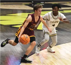  ?? The Sentinel-Record/Grace Brown ?? Q Lake Hamilton’s Zac Pennington (24) drives the ball inside as Hot Springs’ Devren Brown (4) defends during Tuesday’s game at Trojan Arena. The Wolves won, 64-59.