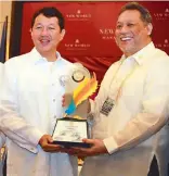  ??  ?? The Philippine STAR president and CEO Miguel Belmonte receives the Hall of Fame award from Rotary Club of Manila (RCM) president Rudy Bediones.