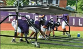  ?? BARRY TAGLIEBER - FOR DIGITAL FIRST MEDIA ?? Phoenixvil­le linemen run through drills on the first day of training camp practice Monday.