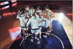  ?? Carmen Mandato / Getty Images ?? The UConn Huskies huddle before the start of the Final Four semifinal against the Arizona Wildcats during the NCAA Women’s Basketball Tournament in San Antonio, Texas, on April 2.