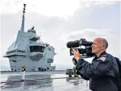  ??  ?? From shipyard to sea: Chris Terrill, left, films HMS Queen Elizabeth, left and above, for a documentar­y; right, a Second World War bomb is detonated; below, aircraft handler Emma Ranson