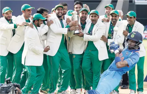  ?? AP ?? Pakistan players celebrate during the award ceremony for the ICC Champions Trophy at The Oval in London yesterday. Pakistan won the final by crushing India by 180 runs.