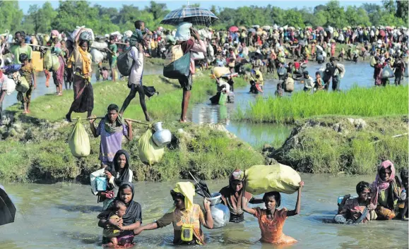  ??  ?? Rohingya refugees fleeing to Bangladesh.