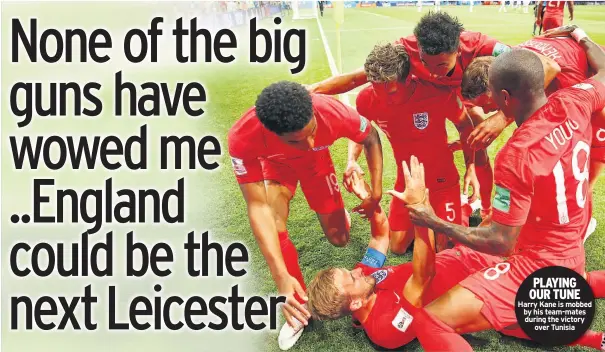  ??  ?? PLAYING OUR TUNE Harry Kane is mobbed by his team-mates during the victory over Tunisia