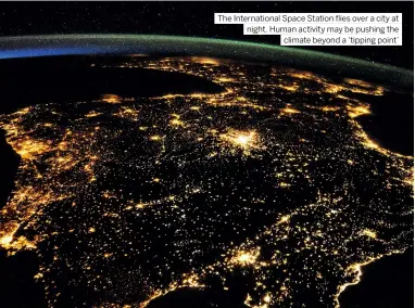  ??  ?? The Internatio­nal Space Station flies over a city at night. Human activity may be pushing the climate beyond a ‘tipping point’