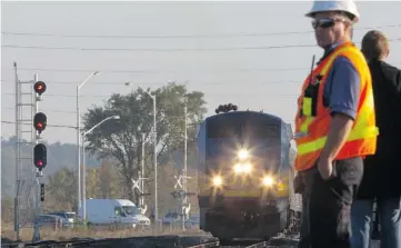  ?? PAT MCGRATH/OTTAWA CITIZEN ?? The first westbound Via Rail train following Wednesday’s crash arrives at the Fallowfiel­d station Friday morning.