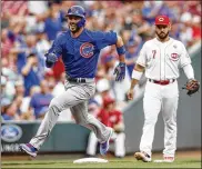  ?? GETTY IMAGES ?? A smiling Kris Bryant rounds third base to score against the Reds on Thursday. There was plenty for the Cubs to be happy about in their 12-5 win as they widened their lead on the second-place Brewers.