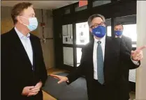  ?? Ned Gerard / Hearst Connecticu­t Media file photo ?? Gov. Ned Lamont, left, with Maritime Aquarium CEO Jason Patlis in February 2021 in Norwalk.