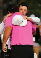  ?? Photo: Reuters ?? Rory McIlroy congratula­tes Patrick Reed on winning the 2018 Masters tournament.