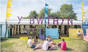  ??  ?? Eisteddfod-goers enjoy the sunshine