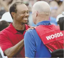  ?? AP PHOTO ?? FINALLY: Tiger Woods (left) celebrates with caddie Joe LaCava after winning the Tour Championsh­ip yesterday at East Lake, his first victory since 2013