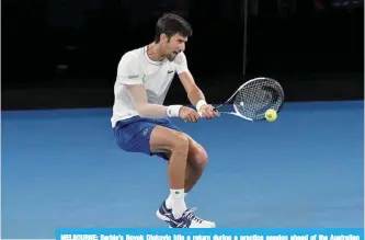  ?? —AFP ?? MELBOURNE: Serbia’s Novak Djokovic hits a return during a practice session ahead of the Australian Open tennis tournament in Melbourne yesterday.