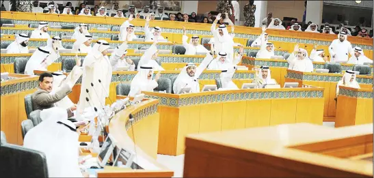  ?? Photo by Rizk Tawfik ?? MPs raise their hands to vote on an issue in Tuesday’s National Assembly session.