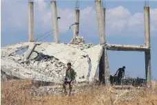  ??  ?? Regime forces near Khan Sheikhoun. The town’s capture is part of a plan to encircle opposition forces in Hama governorat­e