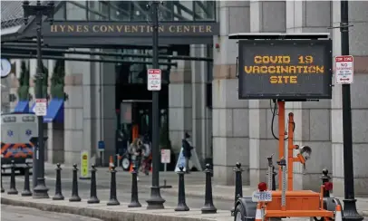  ?? MATT STONE PHOTOS / HERALD STAFF FILE ?? STOCKED: The vaccinatio­n site at Hynes Convention Center in Back Bay will receive an additional 6,000 daily vaccine doses starting at the end of the month. Below, Ricky Cormio of Cataldo Ambulance Service fills a syringe with the Pfizer COVID-19 vaccine on March 19.