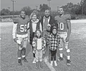  ?? PHOTO PROVIDED ?? Justin White and his family pose with Chandler football players Casmen Hill (10) and Dezmon Taliaferro at a game. White is a former Chandler running backs coach and a house parent at Willow Springs Boys Ranch, where Hill and Taliaferro live.