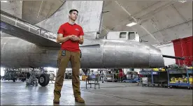  ??  ?? Restoratio­n specialist Casey Simmons with the newly installed tail gunner’s position on the B-17 Memphis Belle. The iconic World War II bomber is being restored at the National Museum of the U. S. Air Force for a May 2018 display debut.