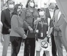  ?? ERIC SEALS/TNS ?? Michigan Gov. Gretchen Whitmer looks on as Penny Cauzillo talks to her about the payload tester she operates on the 2022 Ford F-150 Lightning inside the plant where it will be built, the Rouge Electric Vehicle Center at the Ford Rouge Plant in Dearborn, Mich.