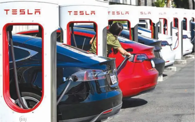  ?? File/associated Press ?? Drivers charge their Teslas in Santa Ana, California.