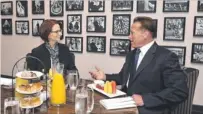  ??  ?? Pep talk: PM Julia Gillard listens to Arnold Schwarzene­gger.