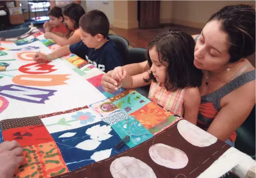  ?? Christian Abraham / Hearst Connecticu­t Media file photo ?? The Norwalk Community Quilt Project: Peace by Piece and community members put together a quilt for the Stepping Stones Museum for Children.