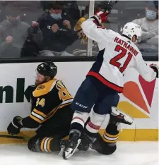  ??  ?? SQUARE IN THE BACK: Jarred Tinordi is slammed into the boards in the third period by Washington’s Garnet Hathaway. Tinordi did not return after the hit and Hathaway received a five-minute major and game misconduct for boarding.