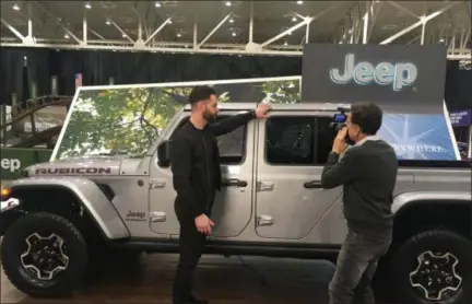  ?? DAVID S. GLASIER —THE NEWS-HERALD ?? Taylor Langhals, lead exterior designer of the new Jeep Gladiator, is interviewe­d by videograph­er Scott Newell.