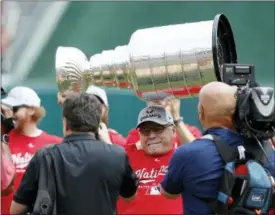  ?? ALEX BRANDON — THE ASSOCIATED PRESS ?? Washington Capitals head coach Barry Trotz lifts the Stanley Cup before a baseball game between the Washington Nationals and the San Francisco Giants at Nationals