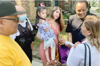  ??  ?? Angelina Rodriguez is held by her mother, Perla Rodriguez, on Saturday outside their West Side home.