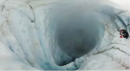  ??  ?? Team members from Simon Fraser University work on a study of gas vents on Mount Meager, near Whistler, in 2016. Climate change is causing glaciers atop the volcano to shrink, increasing the chances of landslides and even an eruption, says one expert.