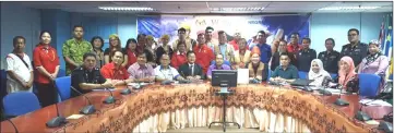  ??  ?? Petrus (seated, fourth right) with members of the organising committee in a photo-call after a meeting with Limbang District Officer Jamalie Busri, who is on Petrus’ right.