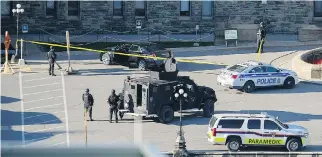  ?? JUSTIN TANG/THE CANADIAN PRESS FILES ?? Police gather on the Hill after last October’s terror attack by Michael Zehaf-Bibeau. Prime Minister Stephen Harper packaged Bill C-51 around the incident and an earlier one in Quebec.