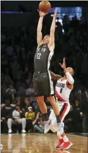  ?? RICH SCHULTZ - THE ASSOCIATED PRESS ?? Brooklyn Nets guard Joe Harris (12) jumps to catch a pass in front of Portland Trail Blazers guard Damian Lillard (0) during the third quarter of an NBA basketball game in New York, Friday, Nov. 24, 2017. The Trail Blazers defeated the Nets 127-125.