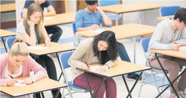  ??  ?? Due to the coronaviru­s pandemic, GCSE students were awarded results based on teacher assessment­s rather than sitting traditiona­l exams, above