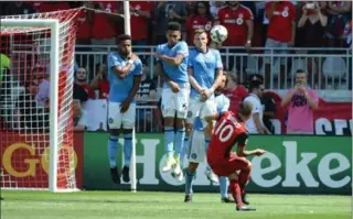  ?? JON BLACKER, THE CANADIAN PRESS ?? FC’s Sebastian Giovinco scores a beauty on a free kick against New York City FC during the second half of their Major League Soccer game Sunday in Toronto. TFC won the contest, 4-0.