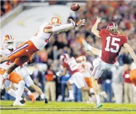  ?? JOHN BAZEMORE/AP ?? Clemson's Tanner Muse partially blocks the punt of Alabama's JK Scott during the first half of the NCAA college football playoff championsh­ip game Monday night.