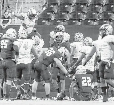  ?? Jon Shapley / Houston Chronicle ?? DeSoto running back Rickie Washington II is lifted by teammates after scoring on a 5-yard touchdown run in the fourth quarter of Saturday’s Class 6A Division II semifinal against Klein Collins. Washington’s score ignited a 21-0 run to close the game...