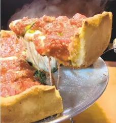  ?? PATRICK EVANS-HYLTON/ FREELANCE ?? The Chicagosty­le, deep dish Windy City Special pizza at Windy City Pizza, is served piping hot from the oven.