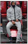  ?? (AP/Kathy Willens) ?? Memphis Grizzlies guard Ja Morant sits on the sideline in his sweats with a boot on his left foot after suffering an injury during Monday’s 116-111 overtime victory over the Brooklyn Nets in New York.