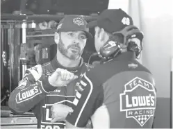  ?? John Raoux/The Associated Press ?? ■ Jimmie Johnson, left, talks with crew chief Chad Knaus in their garage Saturday during a NASCAR auto racing practice session at Daytona Internatio­nal Speedway in Daytona Beach, Fla.