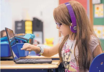  ?? ADOLPHE PIERRE-LOUIS/JOURNAL ?? Hailie Traverse, 8, works on an assignment during her second grade class at Hawthorne Elementary School. Hawthorne has made changes after it was previously designated a school in need of “more rigorous interventi­on.”