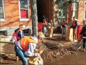  ?? EVAN BRANDT — DIGITAL FIRST MEDIA ?? King Street was abuzz with rakes and shovels Friday as students from Pottstown High School, The Hill School and Montgomery County Community College joined forces for PottstownC­ARES Day.