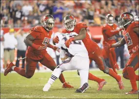  ?? Phelan M. Ebenhack / Associated Press ?? Patriots quarterbac­k Tom Brady (12) is stopped by Buccaneers middle linebacker Kendell Beckwith (51) after scrambling during their game on Oct. 5 in Tampa, Fla. The Patriots won 19-14.