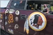  ?? SUSAN WALSH — THE ASSOCIATED PRESS ?? Rodney Johnson of Chesapeake, Va., stands with his truck in Landover, Md., on Monday. The Washington franchise announced that it will drop the “Redskins” name and Indian head logo immediatel­y, bowing to decades of criticism that they are offensive to Native Americans.