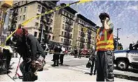  ??  ?? Transport worker helps out at the scene in Harlem