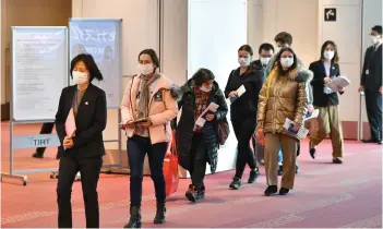  ?? — AFP photo ?? Ukrainians (centre) who have fled the war in their country arrive at Tokyo’s Haneda Airport in Tokyo following a visit to the Polish-Ukraine border by Japan’s foreign minister.