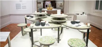  ??  ?? This display of tables and stools — from the Tablescape­s: Designs for Dining exhibit at New York’s Cooper Hewitt Smithsonia­n Design Museum — exemplifie­s ways in which items thought to be non-recyclable can be transforme­d.