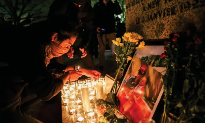  ?? Photograph: Evelyn Hockstein/Reuters ?? A person lights a candle during a vigil following the fatal police shooting of Daunte Wright in Minnesota.